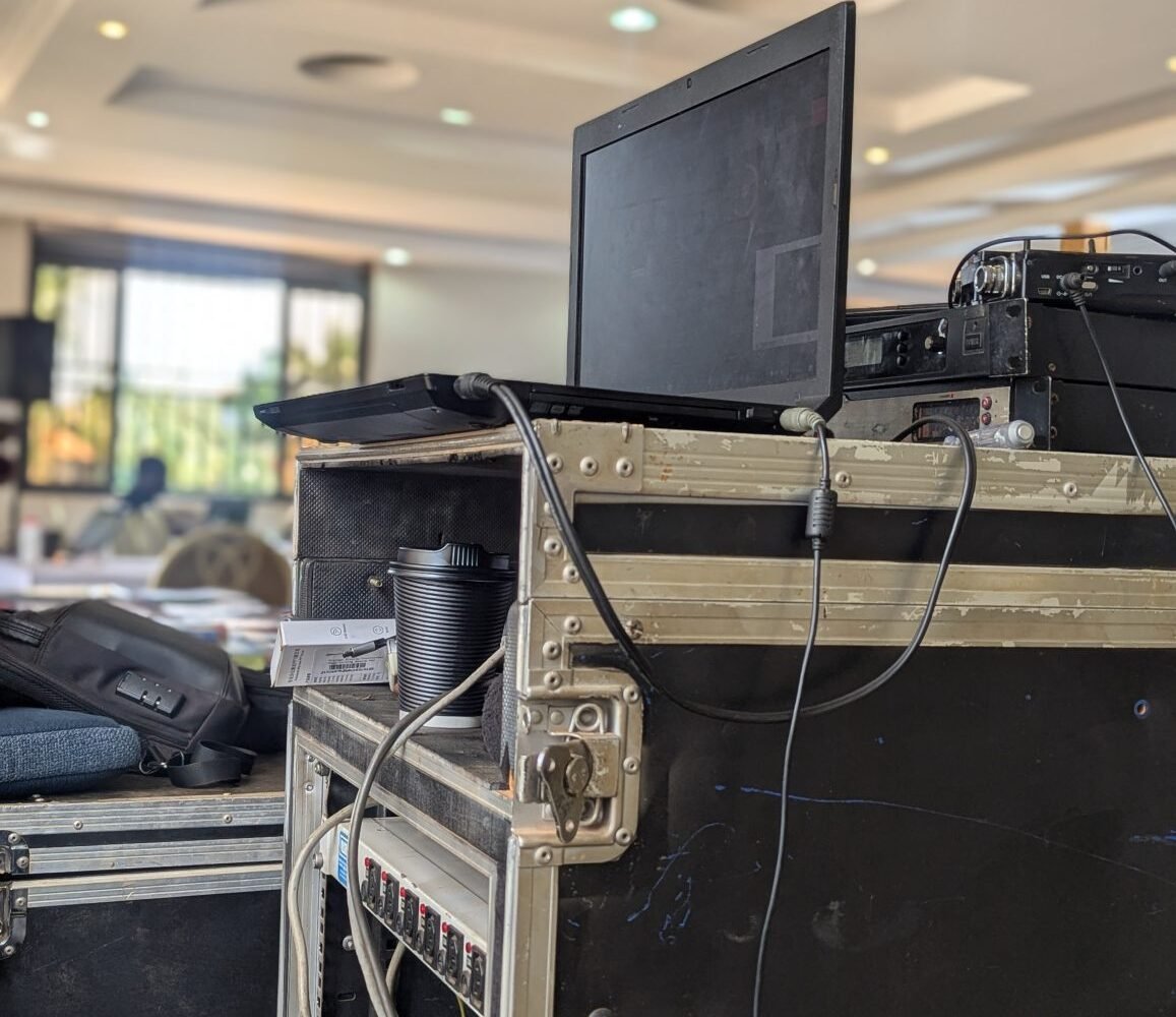 A laptop and connected electronic equipment in a workspace.