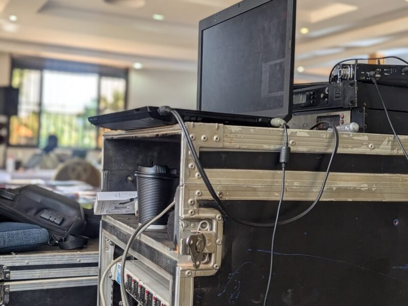 A laptop and connected electronic equipment in a workspace.