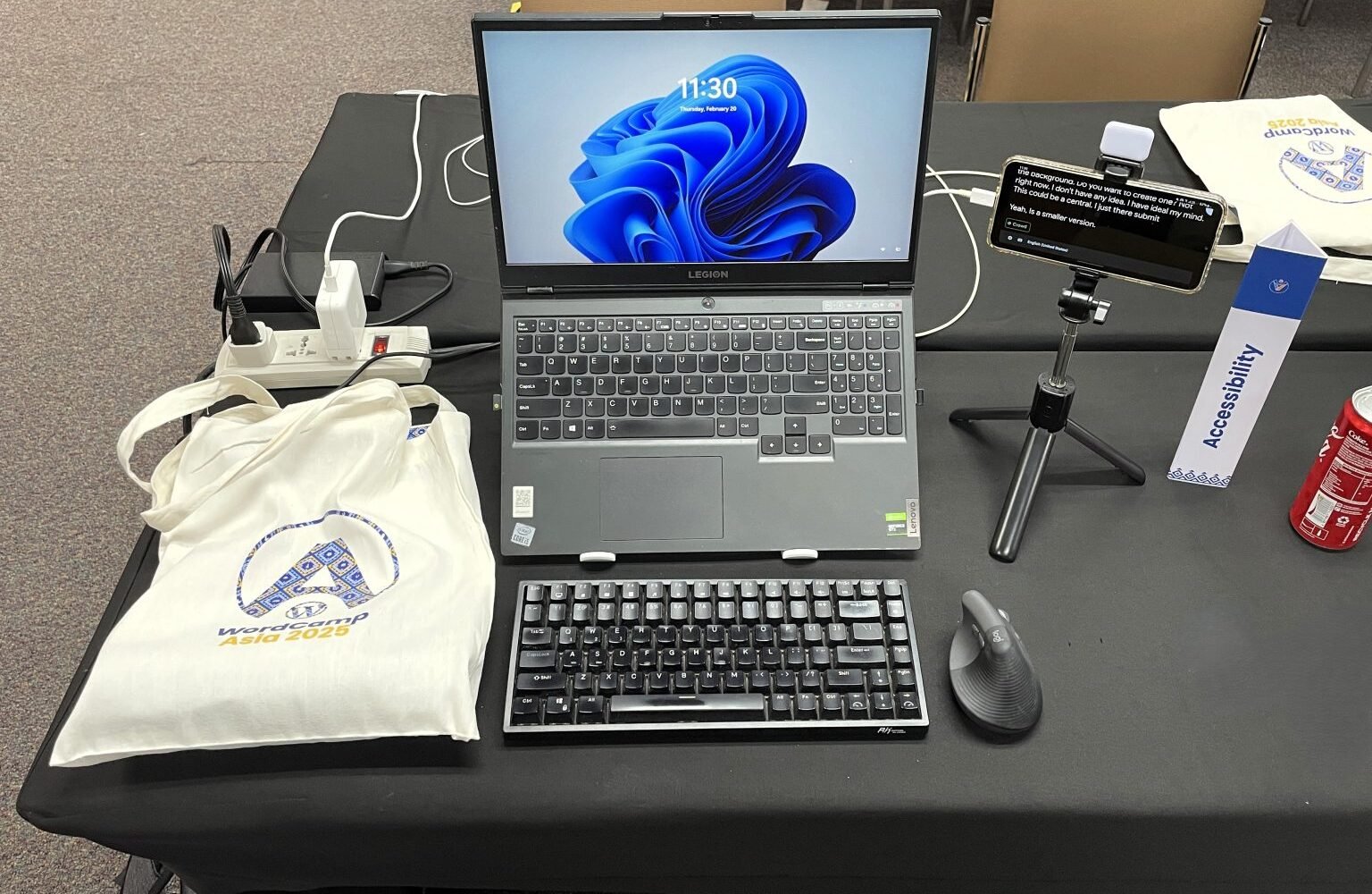 Workplace setup with a laptop, external keyboard, mouse, and phone.