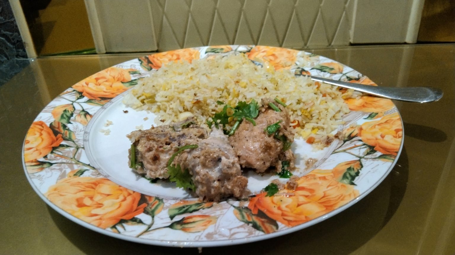 A plate of rice and cooked food served for a meal.